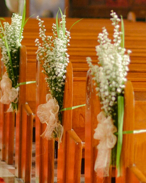 Wedding flowers on church pews